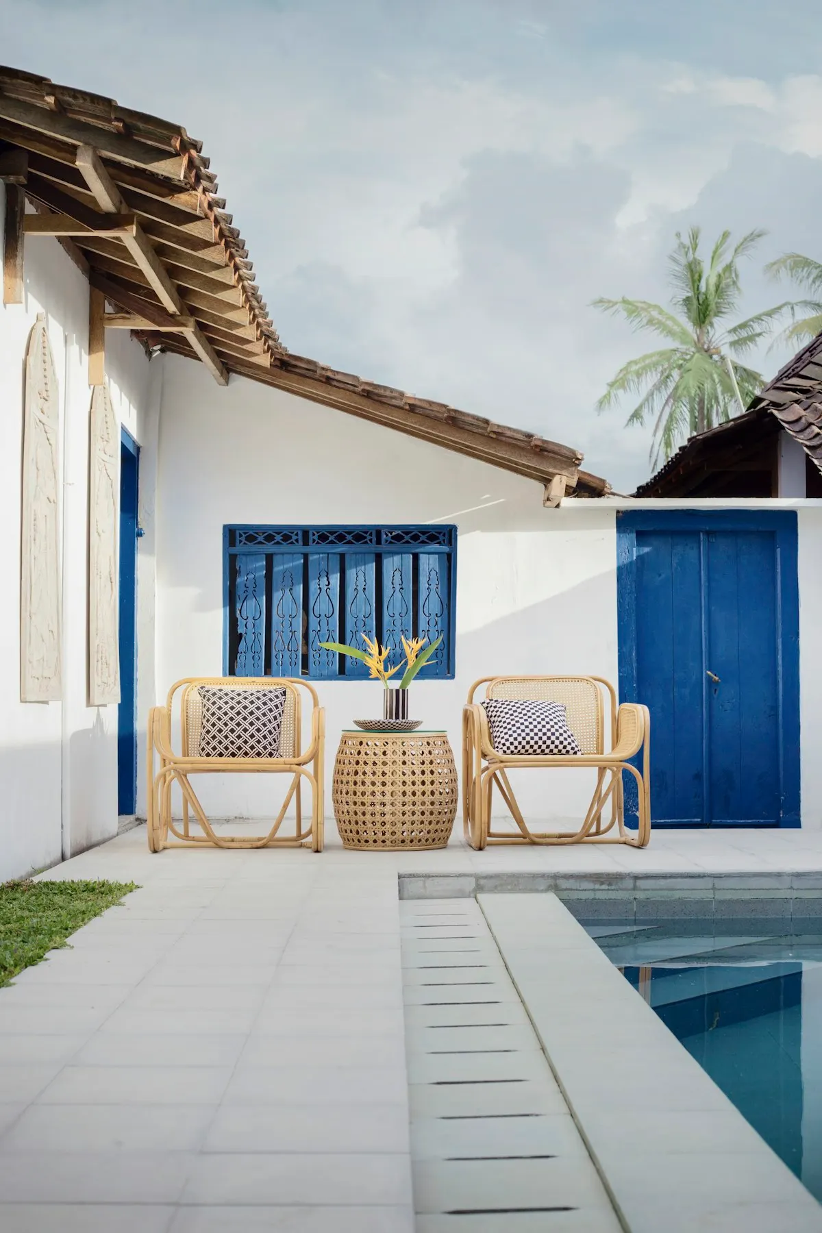 Pale paved terrace beside a swimming pool