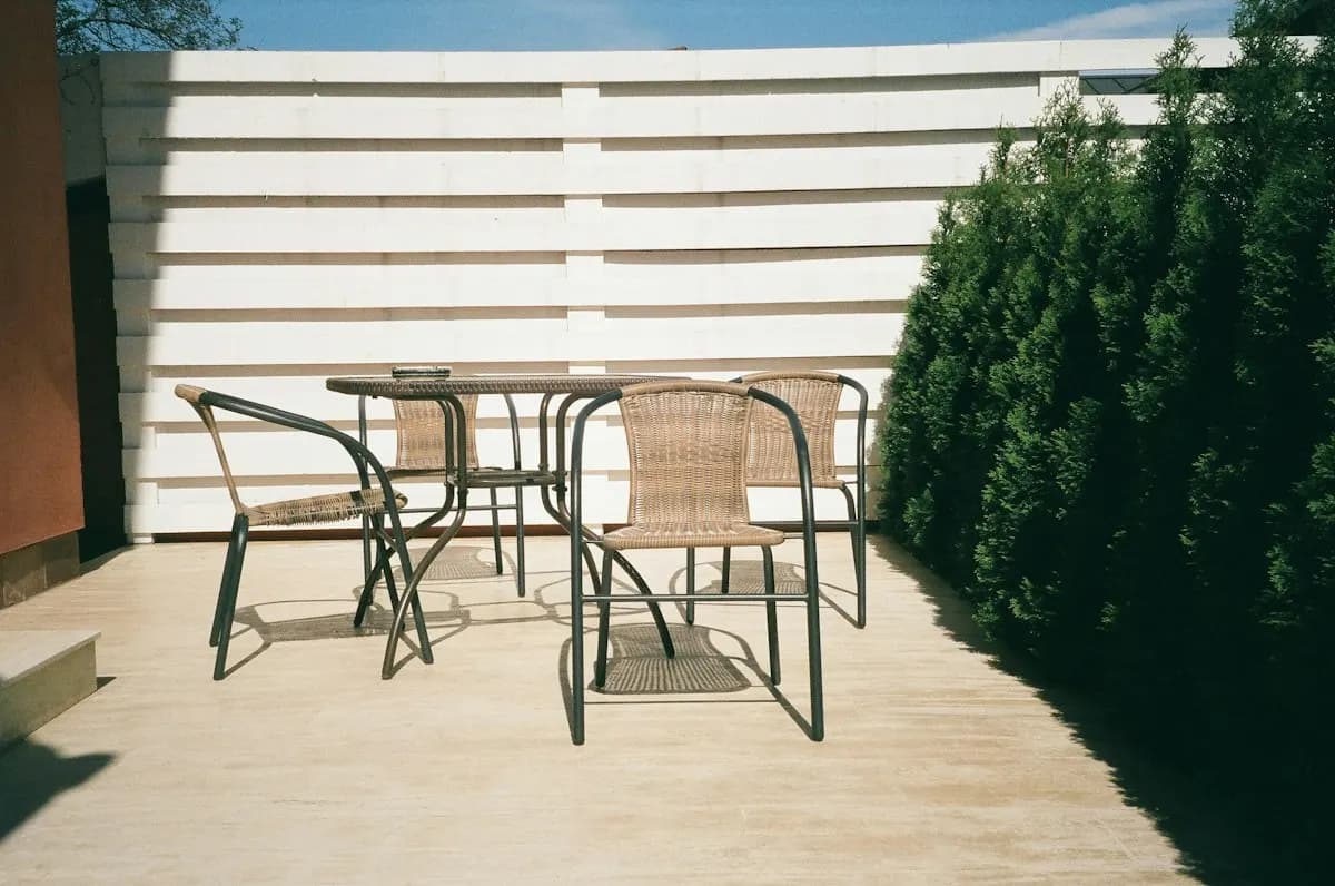 Small paved patio with a table and chairs